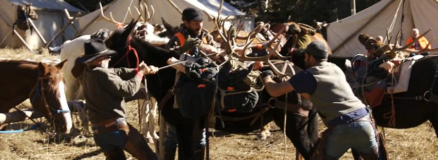Photo of hunters securing antlers to pack animals